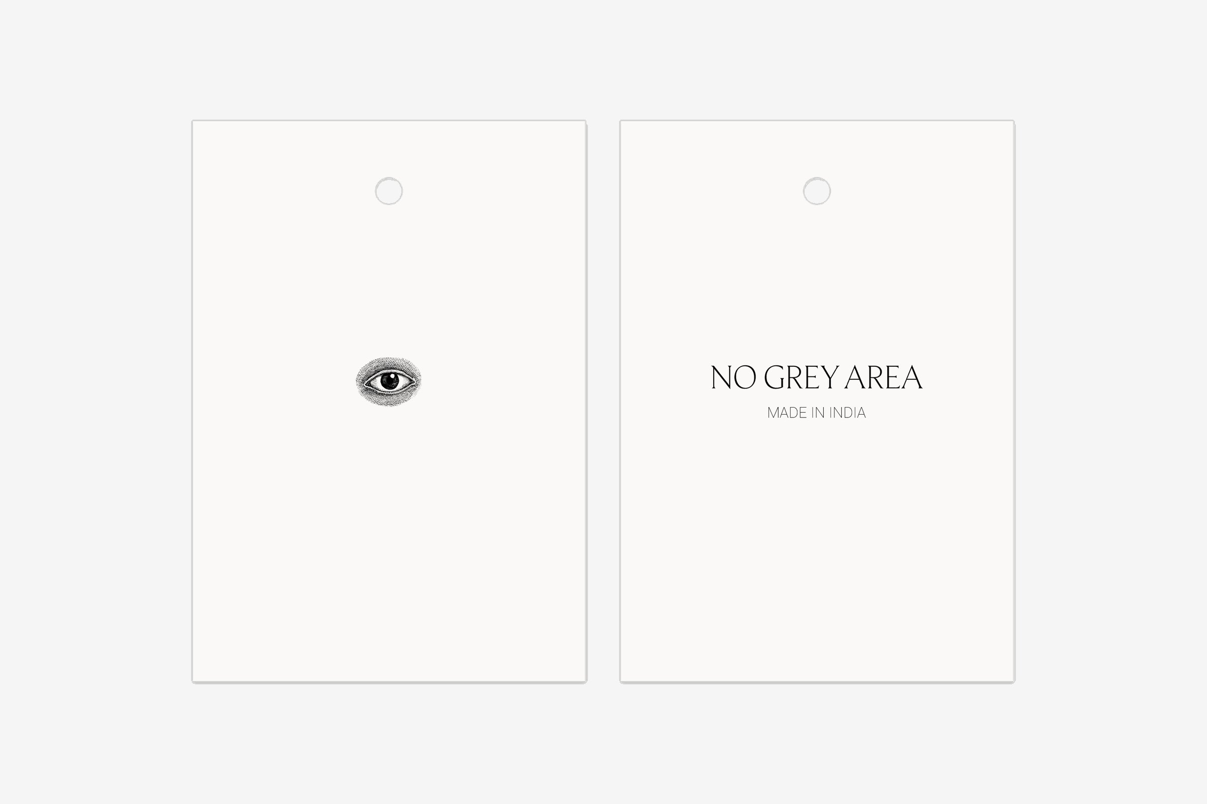 Two hang tags, one with the eye and one with the wordmark and Made in India